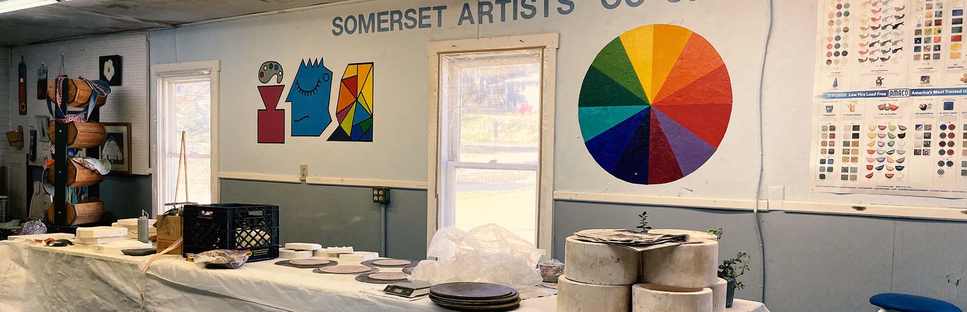 Studio space at the Somerset Artists' Co-op in Somerset, Ohio with vibrant color wheel on the wall.