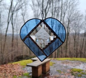 Hanging stained glass heart in a window, created in the Tiffany style at Somerset Artists' Co-Op in Somerset, Ohio.