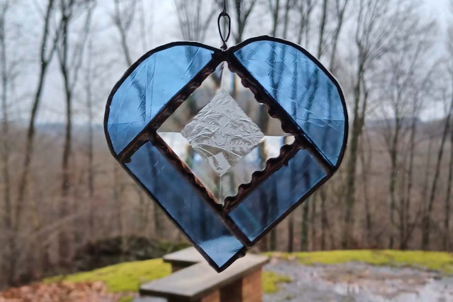 Hanging stained glass heart in a window, created in the Tiffany style at Somerset Artists' Co-Op in Somerset, Ohio.