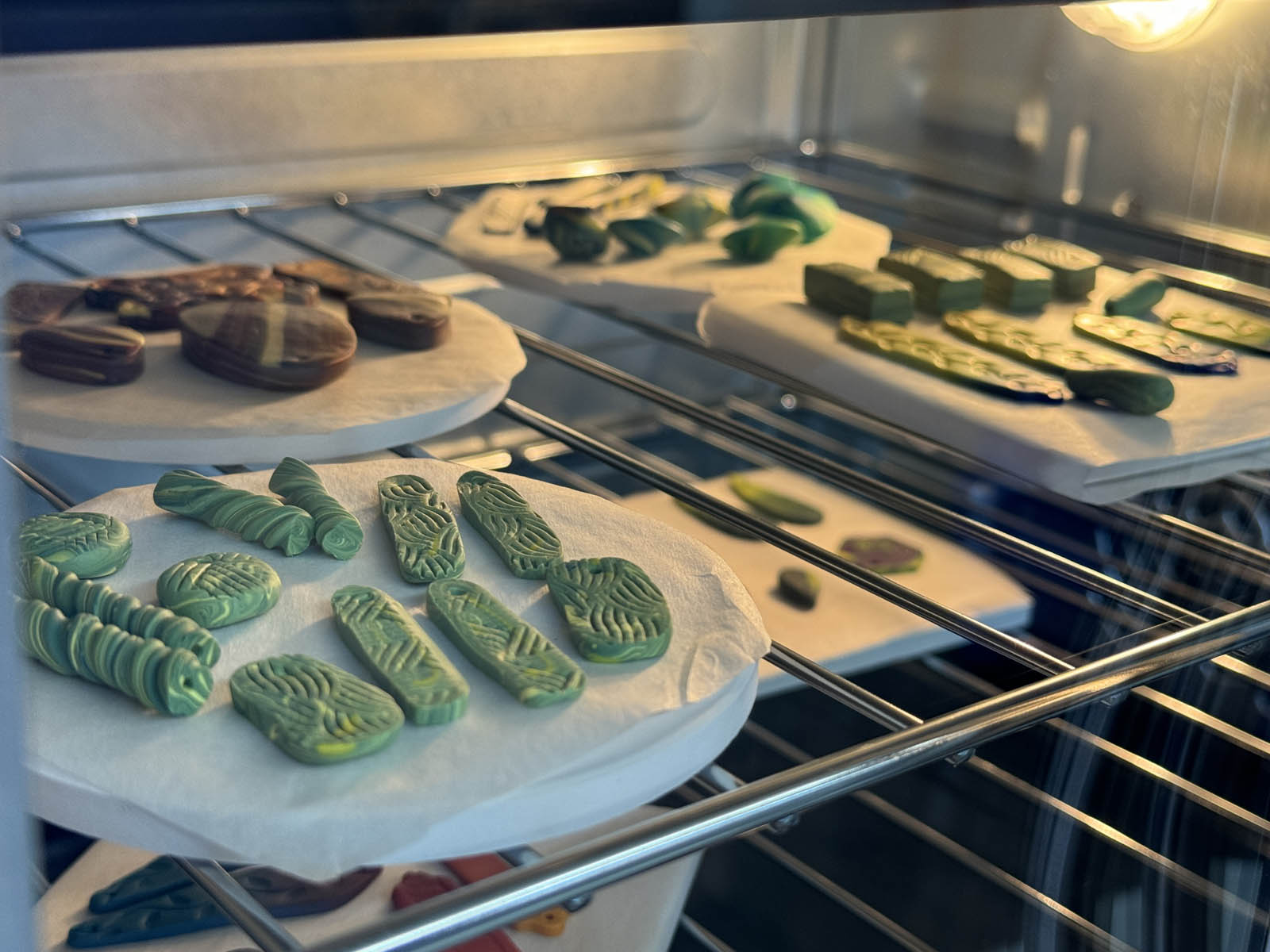 Polymer clay pieces curing in the oven.