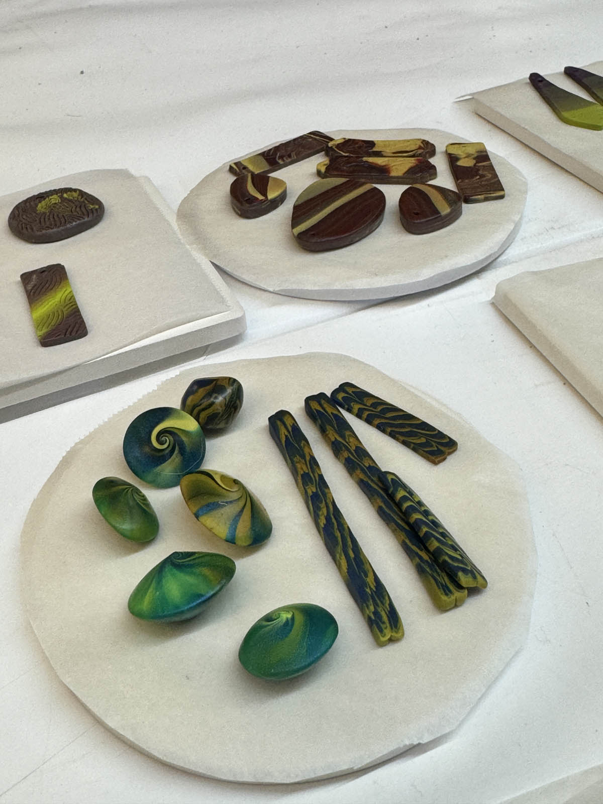 Student polymer clay pieces post-curing in the oven at the Somerset Artists Co-Op.