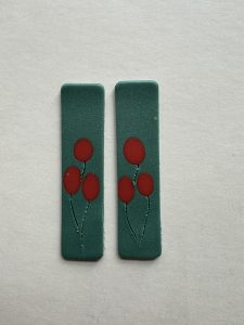 Polymer clay earrings with embedded color prior to baking.