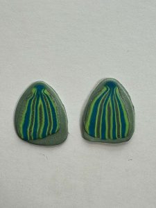 Polymer clay earrings with embedded cane pattern, prior to baking.