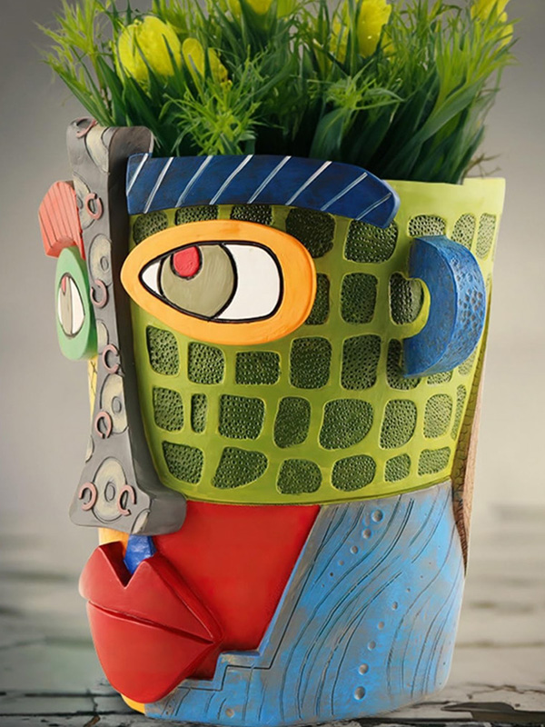 A ceramic handmade planter in the style of Picasso.