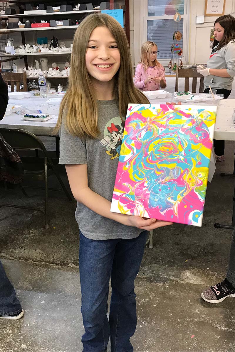 Student in the Somerset Artists' Co-Op Summer Kids Camp shows her painting.