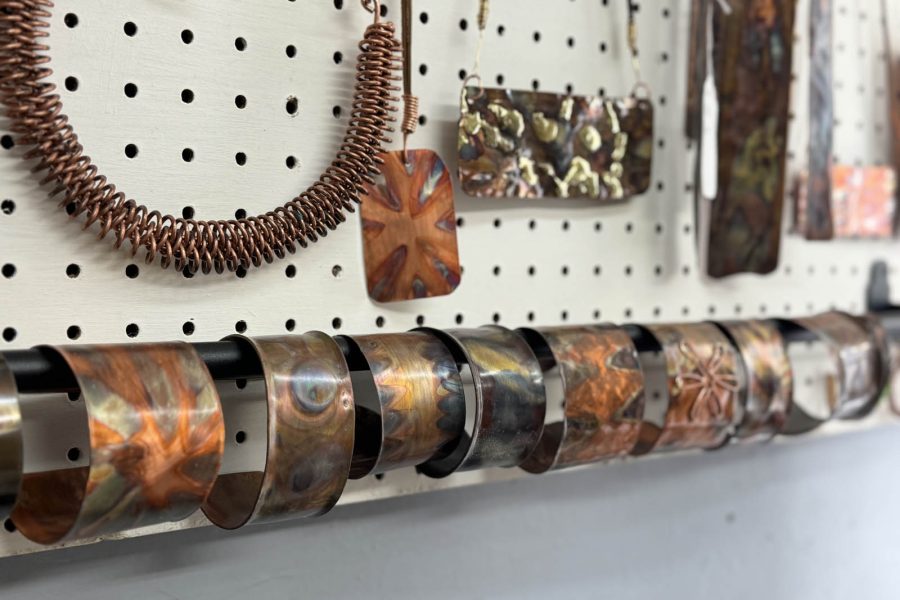 Display of fired copper cuffs and necklaces by. Denny Young at the Somerset Artists' Co-Op.