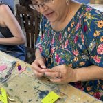 Student working on polymer clay earring design at the Somerset Artists' Co-Op.