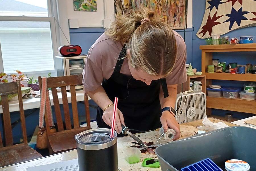 Student creating a Tiffany-style stained glass piece at the Somerset Artists' Co-Op in Somerset, Ohio.