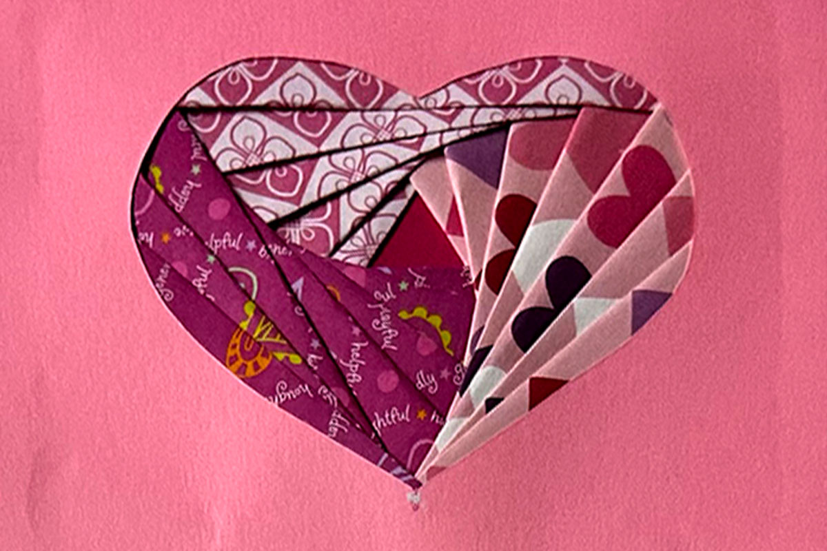 Handcrafted paper card in a heart shape.