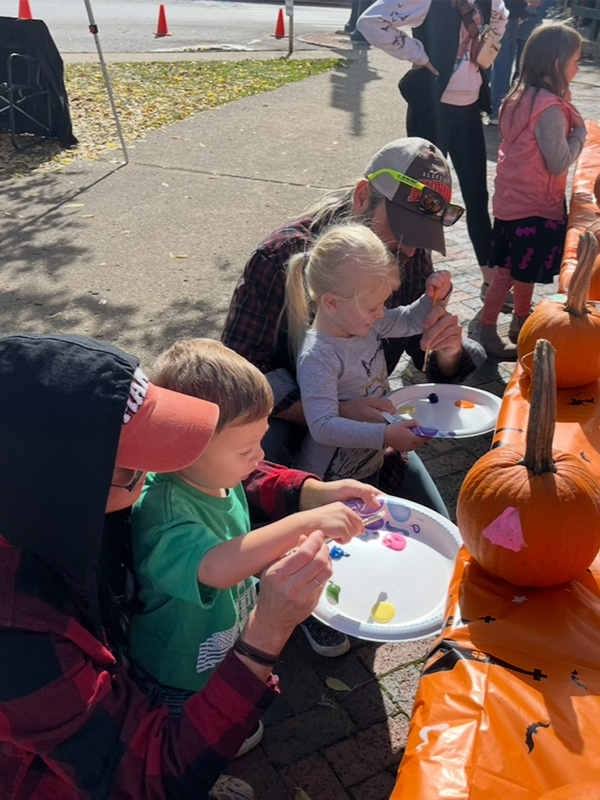 Children painting pumpkins during Scare on the Square in Somerset, Ohio.